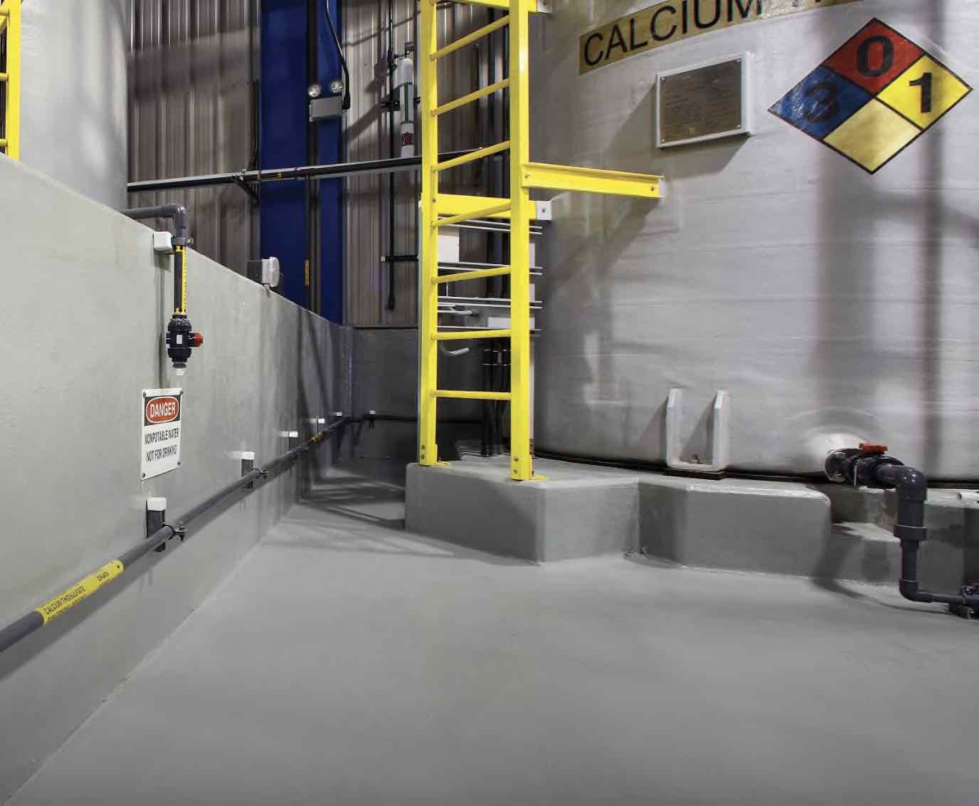 Secondary containment coating system around a chemical storage tank