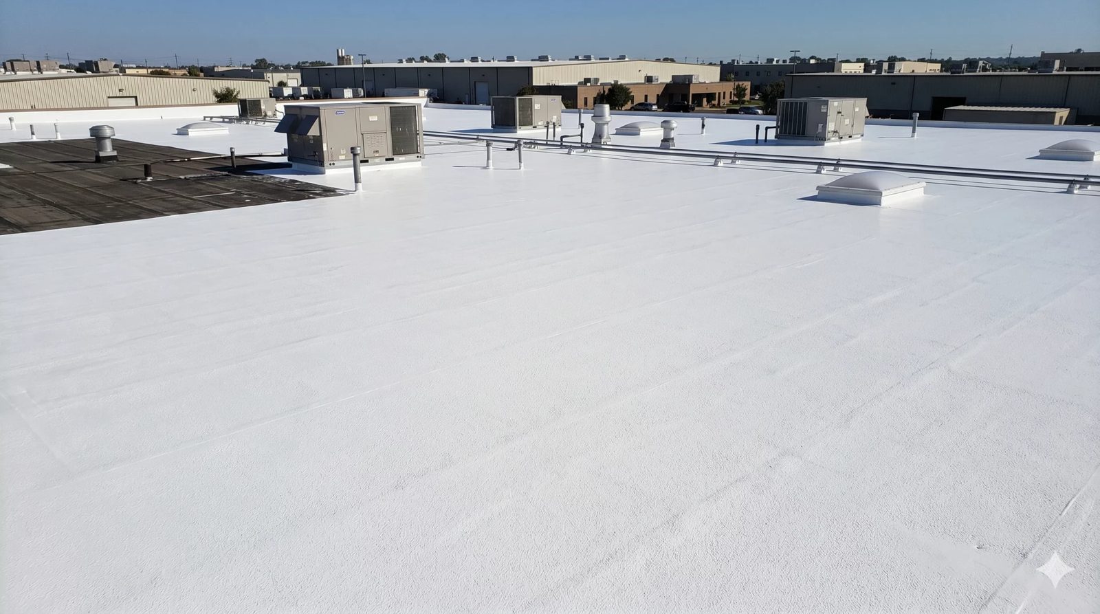 Commercial roof coating system applied over a flat industrial roof
